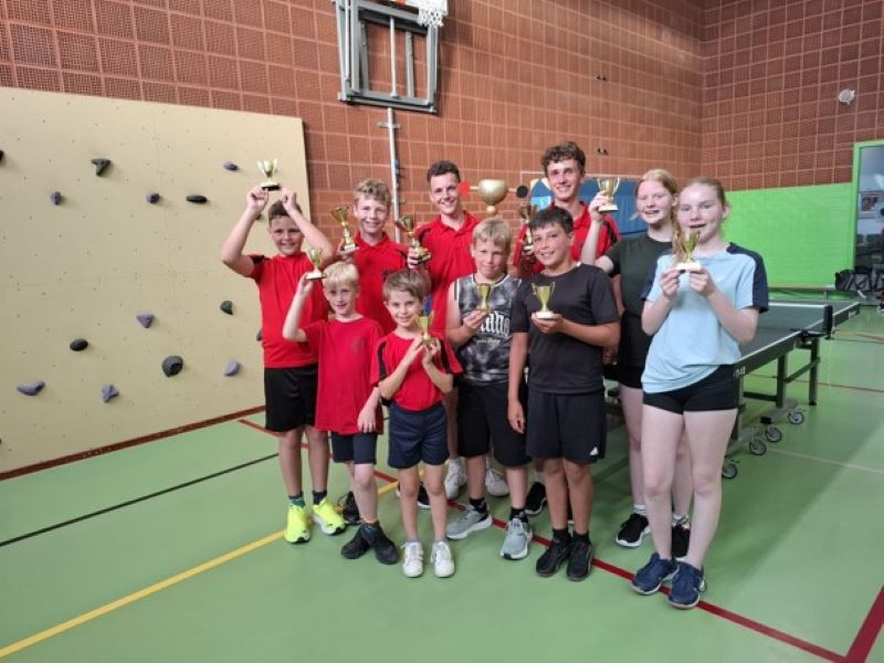 De clubkampioenen allemaal met een beker in hun hand in de sportzaal