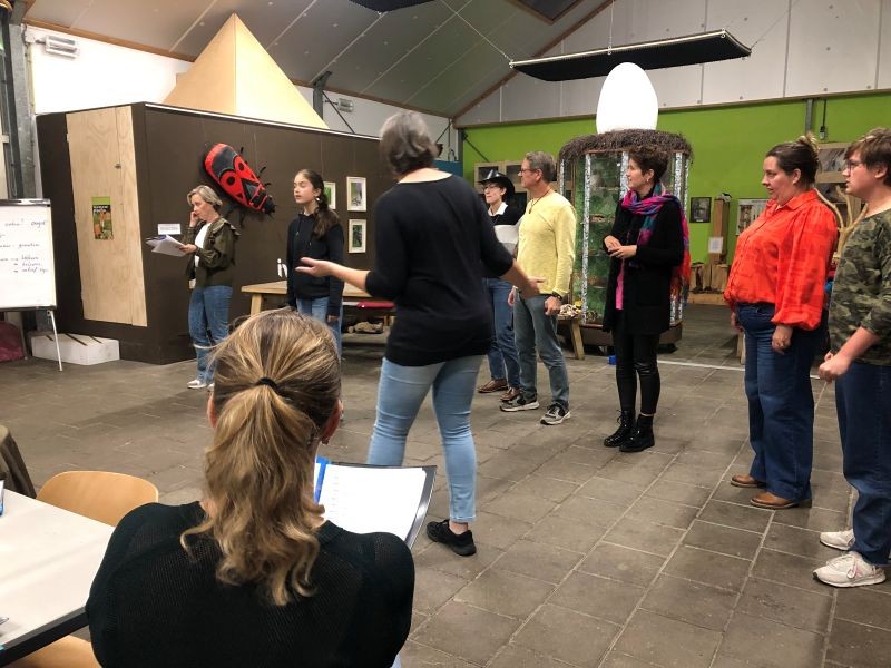 Mensen staan op een rijtje en lezen tekst op.