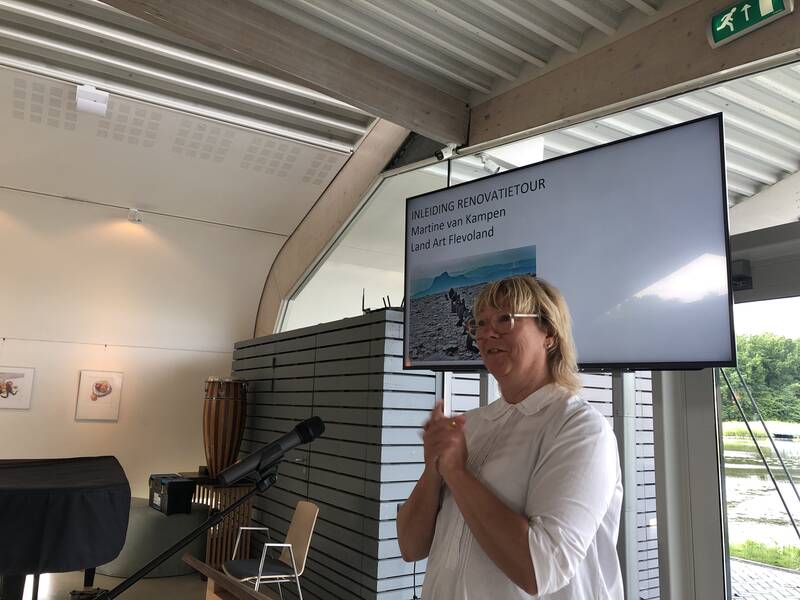 vrouw staat voor een beeldscherm met haar handen bij elkaar