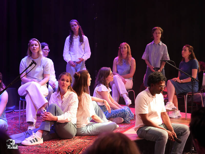 groep mensen zingend op een podium